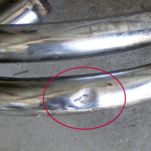 Small dent on header pipe #1